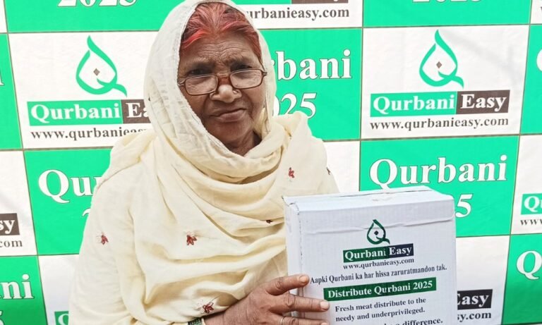 A woman holding a box of Qurbani meat distributed by Qurbani Easy in 2025