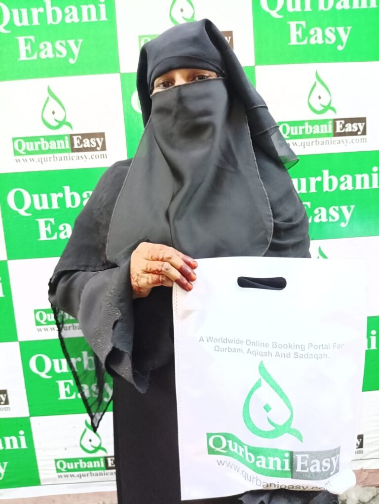 A woman holding a Qurbani Easy bag after a Qurbani meat distribution
