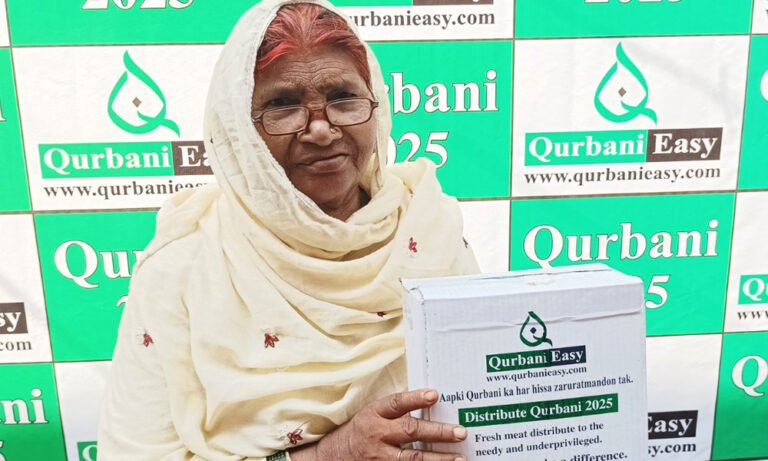 A woman holding a box of Qurbani meat distributed by Qurbani Easy in 2025