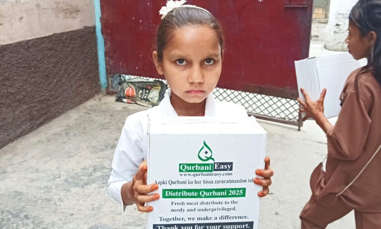 A girl holding a box of Qurbani meat distributed by Qurbani Easy